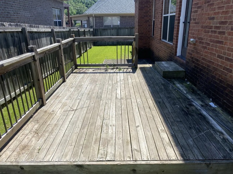 Weathered gray wood deck before cleaning