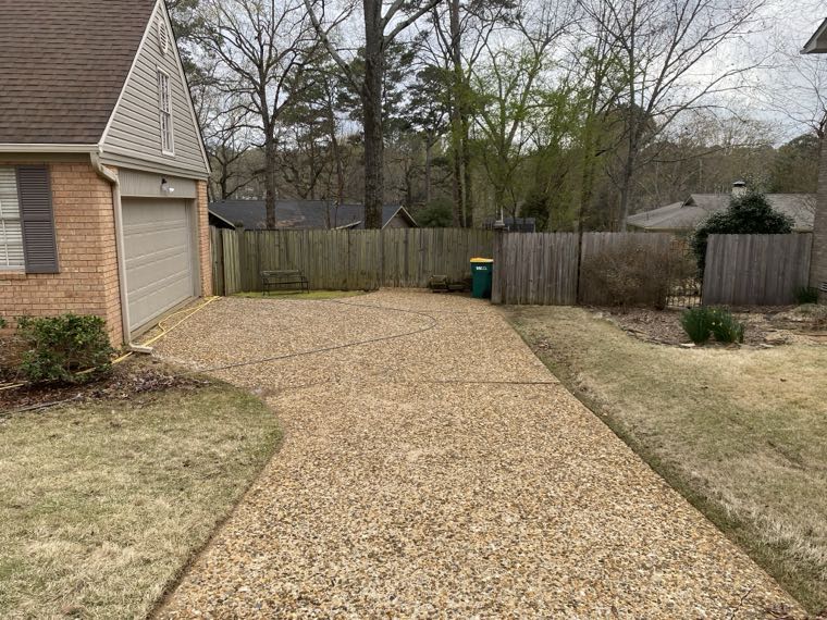 Exposed aggregate driveway after surface cleaning, clean gold stone visible
