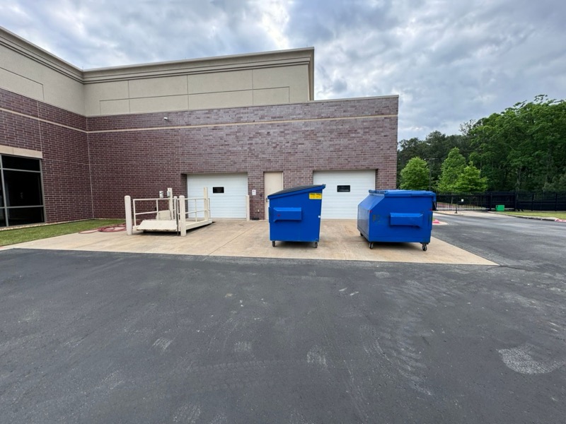 Dumpster enclosure and pad at a commercial property