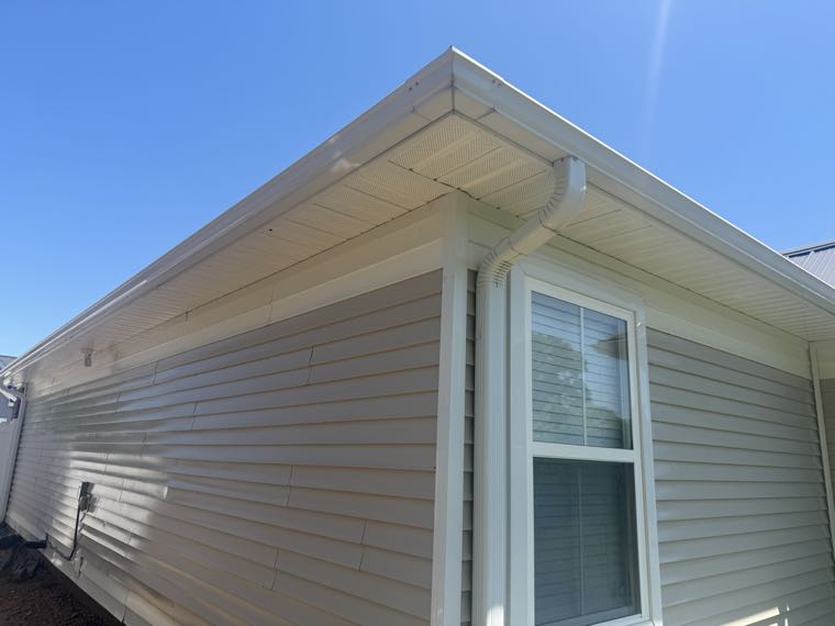 The same eaves and soffit after cleaning, bright and clean