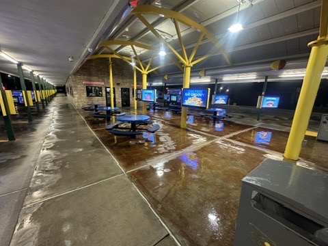 Covered commercial parking and drive-through area, freshly cleaned and still wet