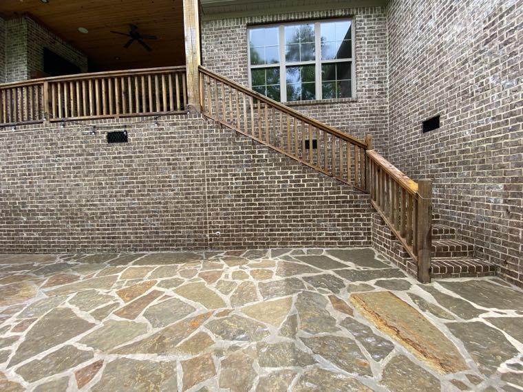 Brick wall and flagstone patio after cleaning, staining removed from both surfaces