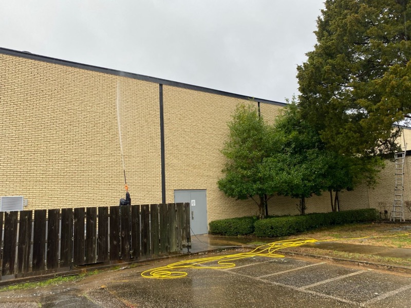 Commercial building exterior wall being surface washed