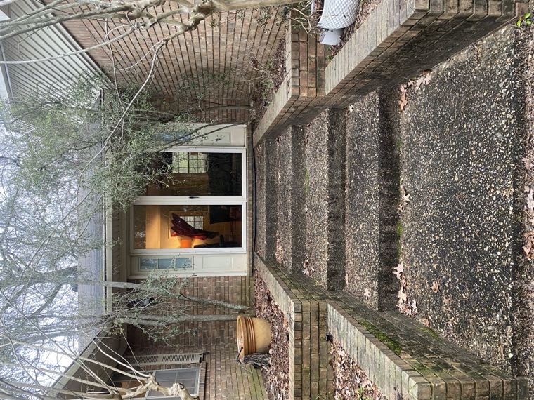 Aggregate walkway and steps darkened with dirt and leaves before cleaning